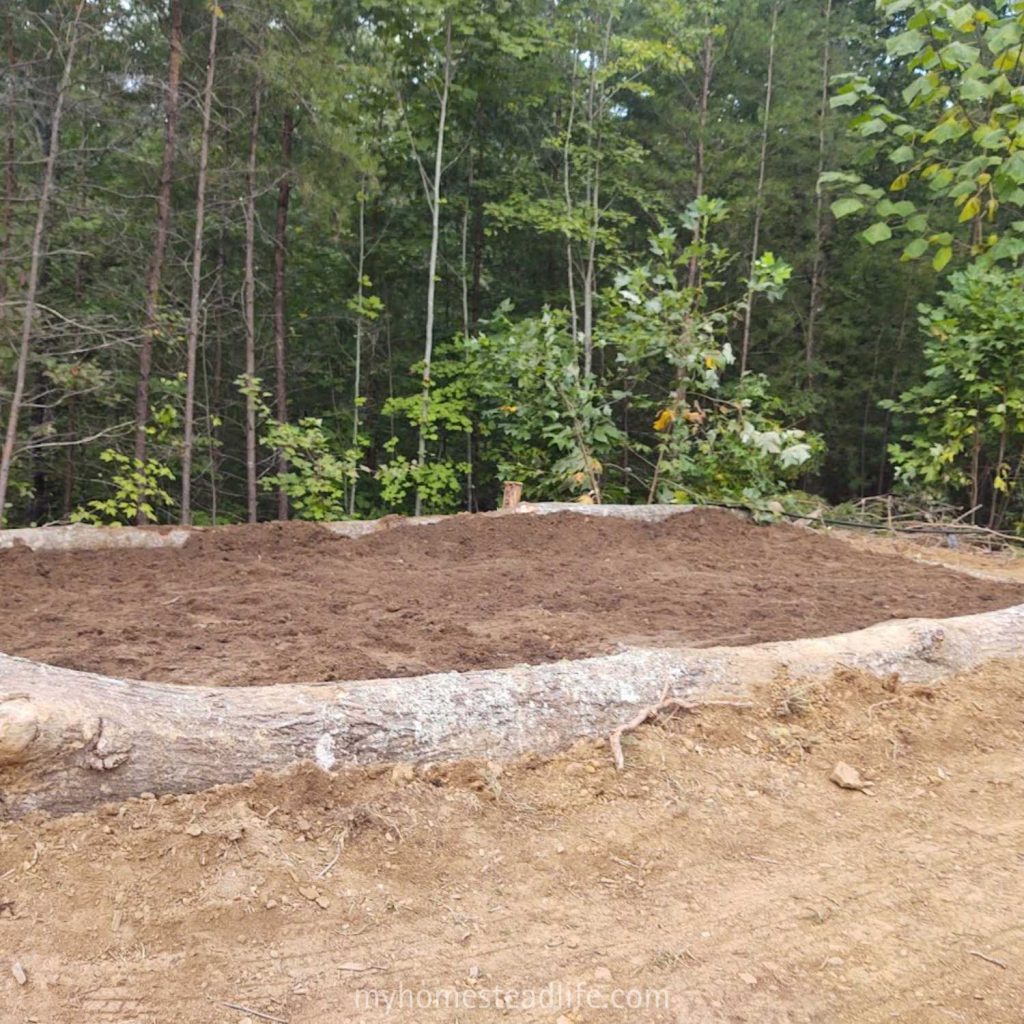 new garden soil in our big garden with felled tree border